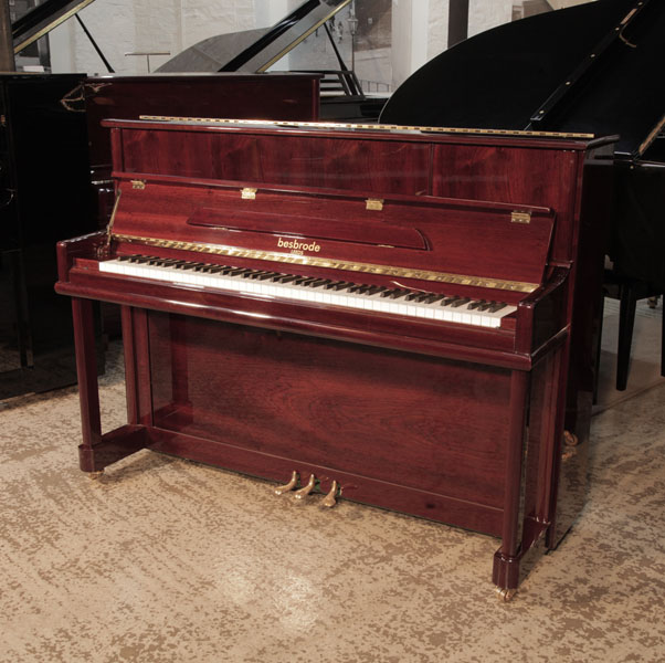 Reconditioned 2016,  Besbrode SU112  upright piano for sale with a mahogany gloss case and brass fittings Piano has an eighty-eight note keyboard and three pedals.  