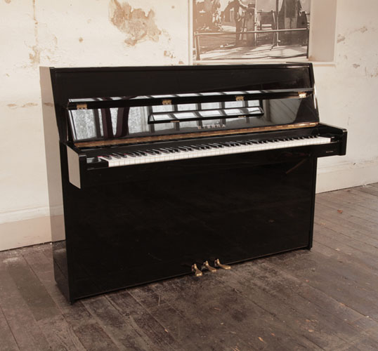 Reconditioned 1997, Eterna ER-C10 upright piano for sale in black gloss.  Piano has an eighty-eight note keyboard and and three pedals 