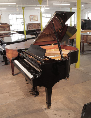 A 2017, W. Hoffmann V158 baby grand piano for sale in black gloss. Piano has an eighty-eight note keyboard and a three-pedal lyre. 