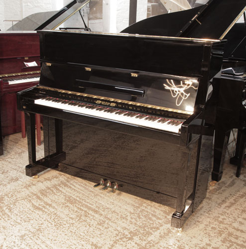 Reconditioned 2016, Perzina GP-129  upright piano in black  gloss with brass fittings.  Piano has an eighty-eight note keyboard and and three pedals 