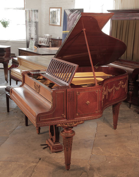 Empire Style,  1901, Schiedmayer grand piano for sale with a quarter cut mahogany case. Entire cabinet features ormolu mounts of beading, swags, bows and festoons. Piano has an eighty-five note keyboard and a two-pedal lyre. Piano has an eighty-five note keyboard and a two-pedal lyre.