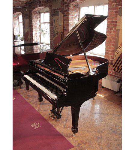 A 1996, Steinway Model M grand piano with a with a black case. Piano has an eighty-eight note keyboard and a three-pedal lyre.