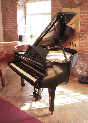 Reconditioned,  1925, Steinway Model S baby  grand piano with a black  case and spade legs. Piano has an eighty-eight note keyboard and a two-pedal lyre. 