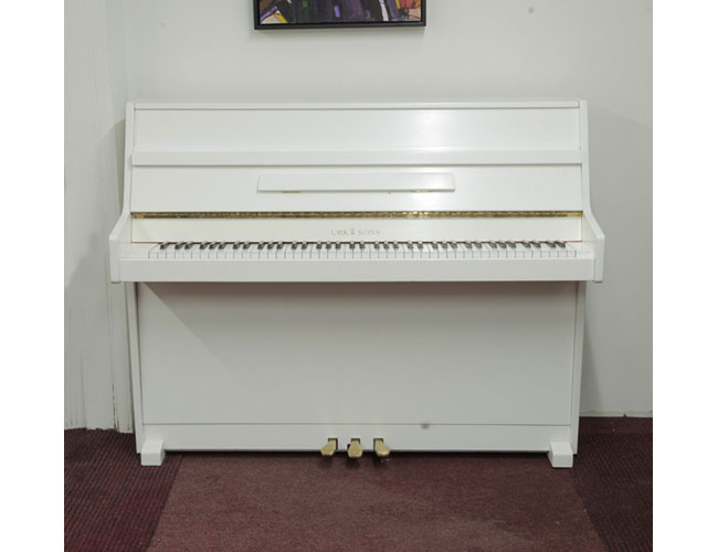 Pre-owned, Urk & Sons VU 110 upright piano with a white gloss case. Piano has an eighty-eight note keyboard and three pedals.  